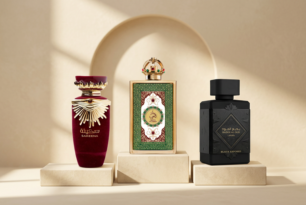 Perfumes Lattafa Sakeena, Queen of Arabia e Bade’e Al Oud Black Exposed sobre pedestais em tons champanhe.