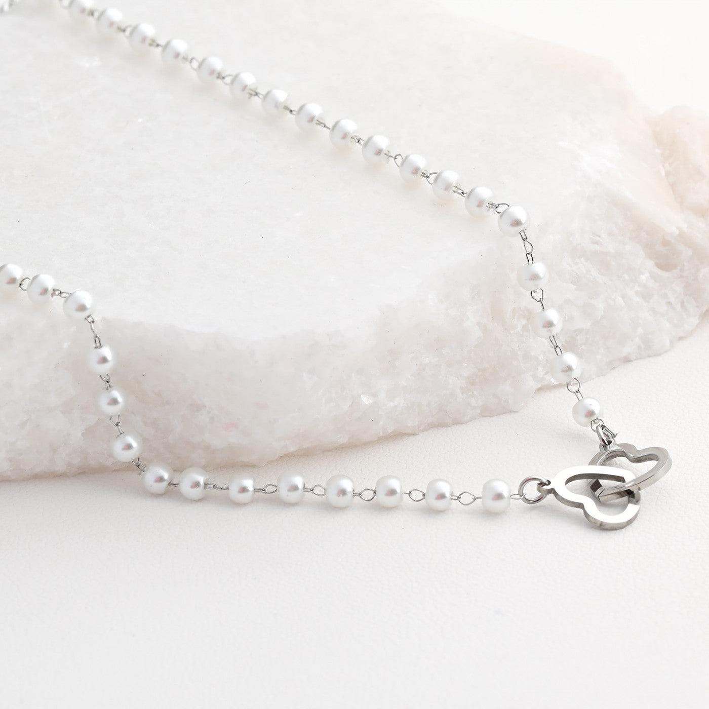 Steel necklace with intertwined hearts and polka dots 