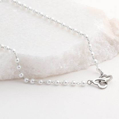 Steel necklace with intertwined hearts and polka dots 