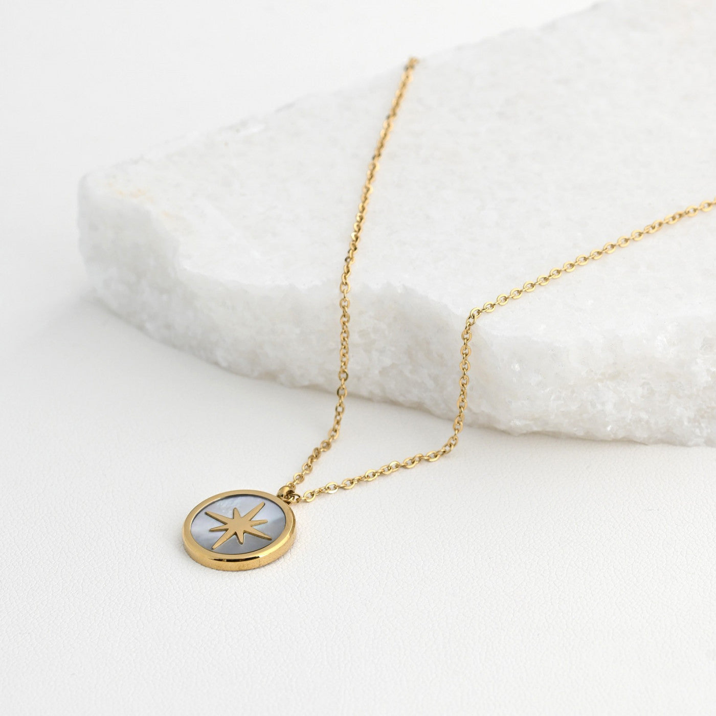 Steel necklace with mother of pearl and a star. 