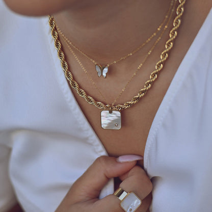 Square steel necklace with mother of pearl. 