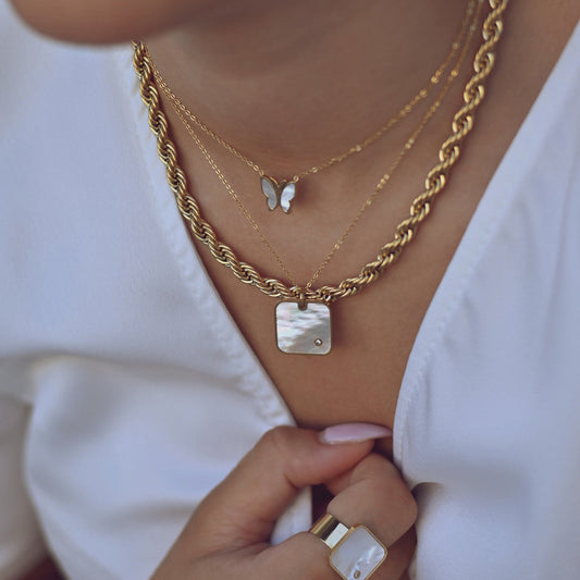 Square steel necklace with mother of pearl. 