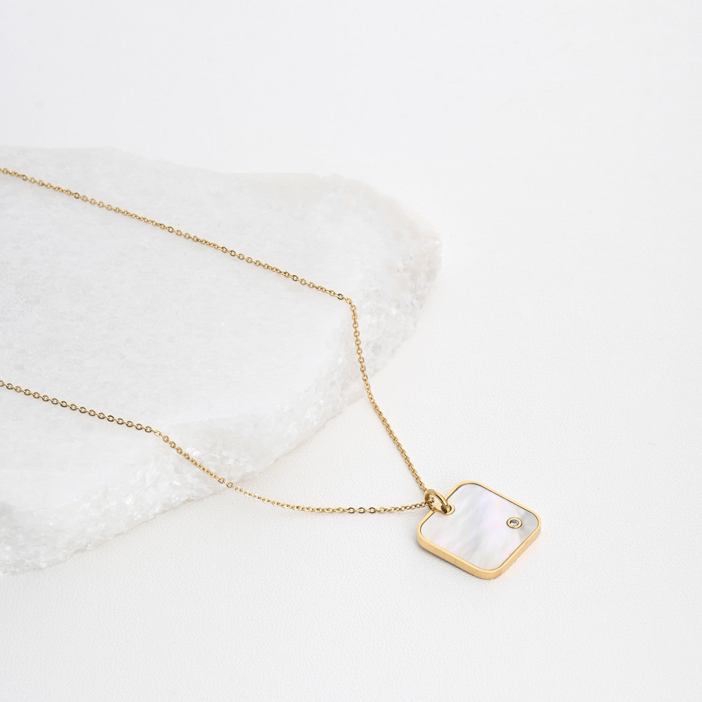 Square steel necklace with mother of pearl. 